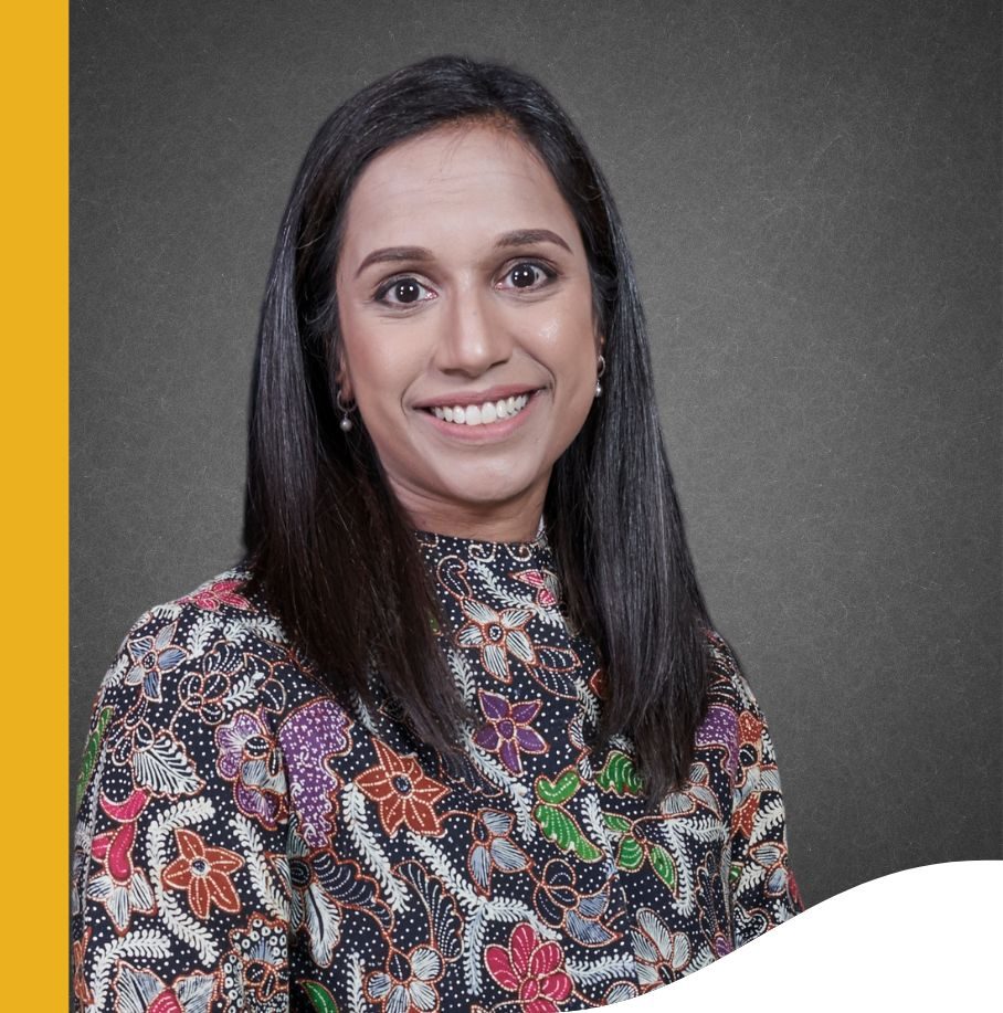 Image of a woman smiling and wearing a printed shirt