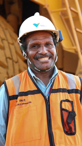 Smiling man poses for a photo wearing vest, helmet and Vale uniform.