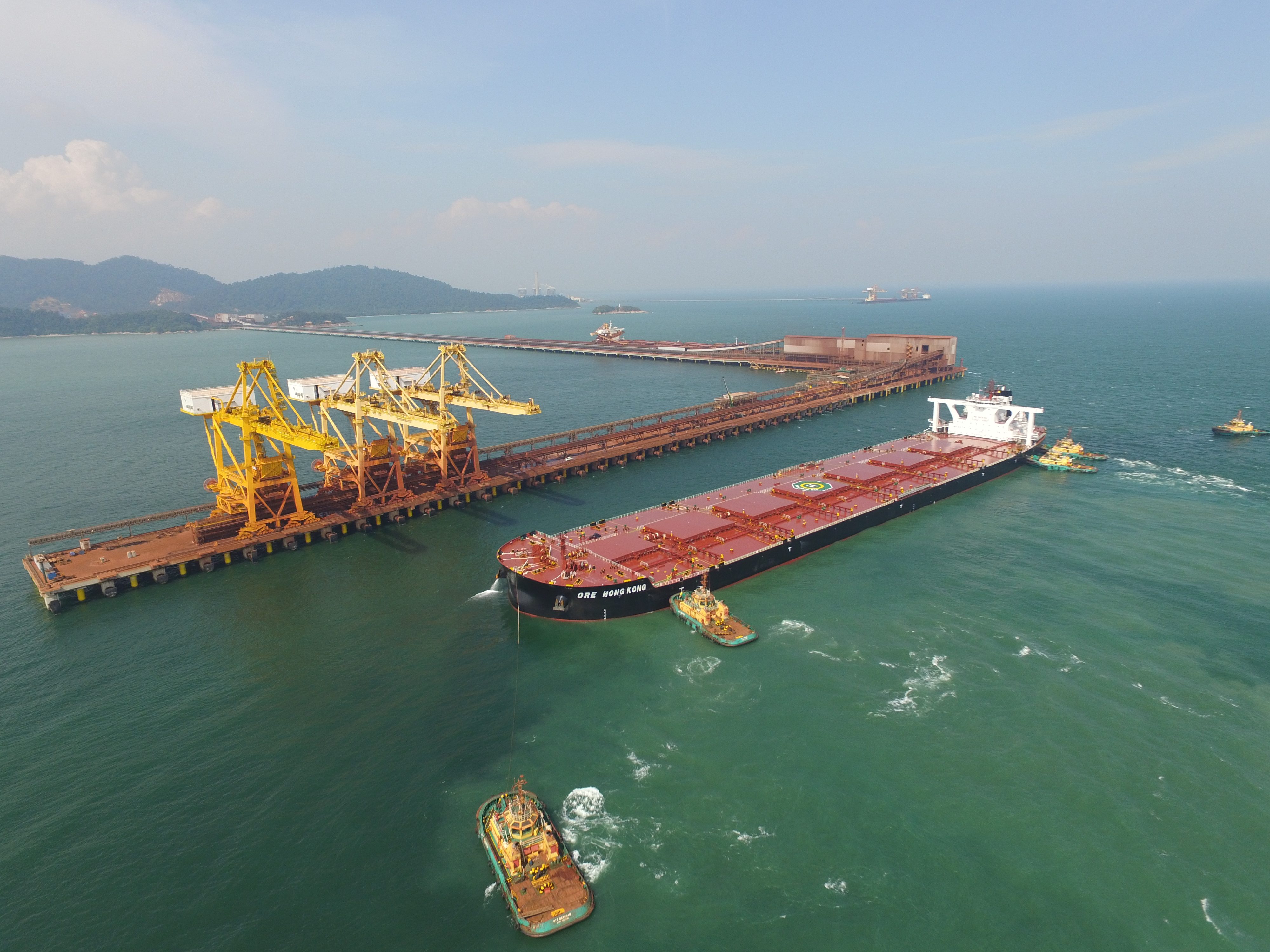 Aerial image of a maritime platform with a cargo ship next to it