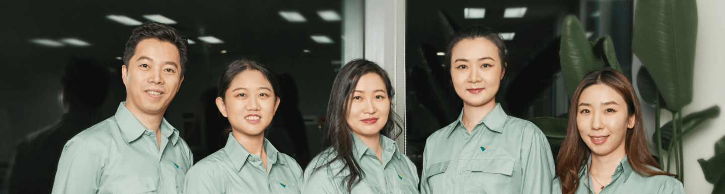 One man and four women Vale employees in China pose for a photo, all wearing uniforms