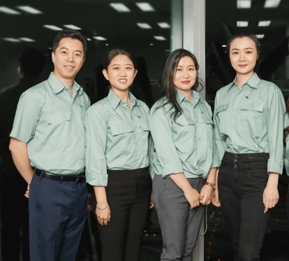 One man and four women Vale employees in China pose for a photo, all wearing uniforms