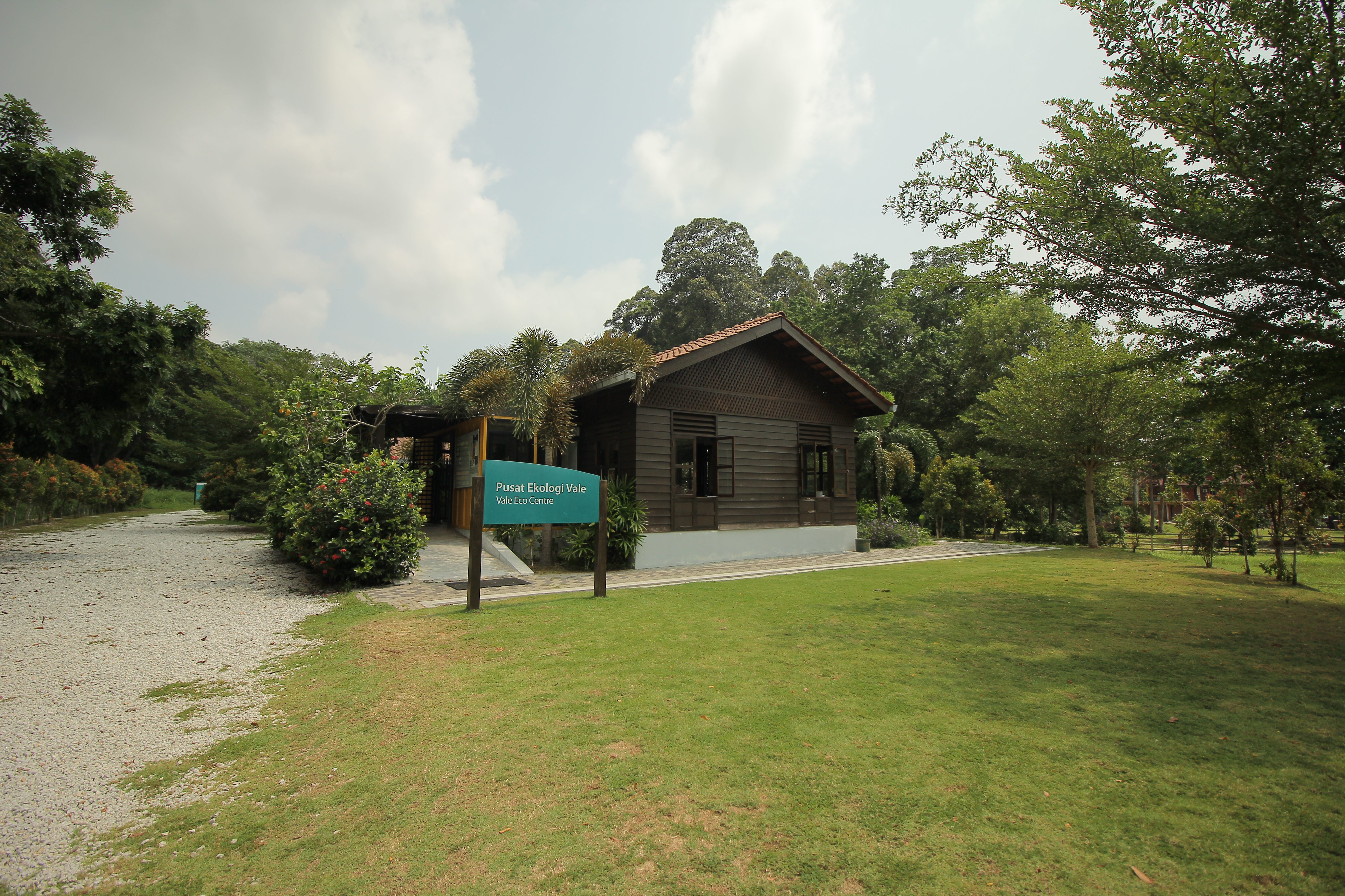 Image of a grassy space with a house in the background and a "Vale Eco Center" sign in front