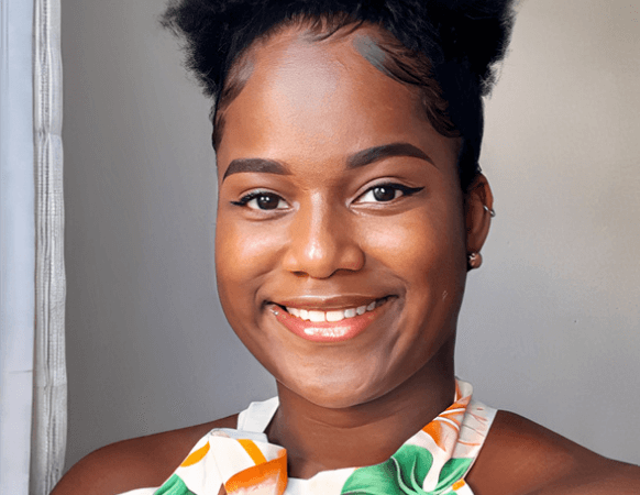 Photo of the face of a black woman smiling.