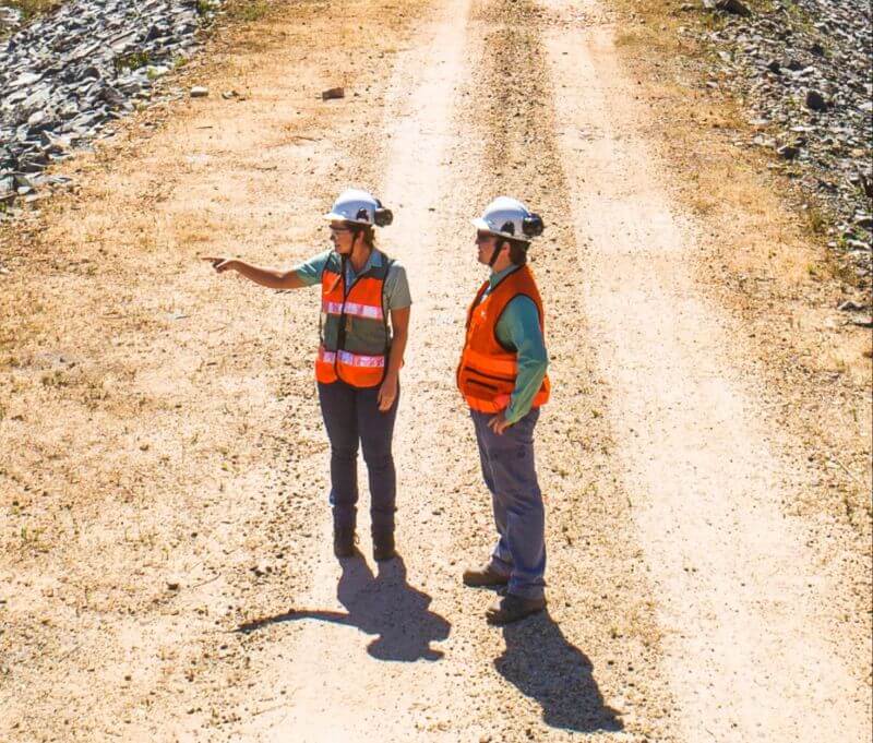 Vale employees on a dirt road analyzing the operation