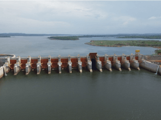 Photo of the Machadinho Hydropower Plant with a concrete structure and moving water passing through the structures.